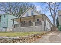 Charming renovated home featuring a covered front porch and stone foundation at 966 Ashby Grove Sw St, Atlanta, GA 30314