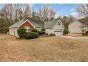 A well-maintained single-story home featuring a neat yard and attached two-car garage at 1584 Snow Hill Dr, Lawrenceville, GA 30045
