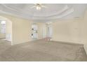 Spacious carpeted living room with trey ceiling, and open access to the kitchen and dining areas at 1584 Snow Hill Dr, Lawrenceville, GA 30045