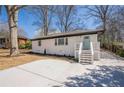 Attractive home with a well-manicured lawn, concrete driveway, and inviting facade at 3095 Wills Se St, Smyrna, GA 30080