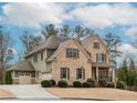 Lovely two-story brick home showcasing attached garage, complemented by well-maintained landscaping at 3621 Sutters Pond Way, Kennesaw, GA 30152