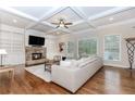Cozy living room with fireplace, built-ins, and coffered ceilings at 3621 Sutters Pond Way, Kennesaw, GA 30152