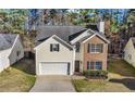 Charming two-story home featuring brick and siding, a manicured lawn, and an attached two-car garage at 414 Shadetree Ln, Lawrenceville, GA 30044