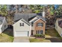 Charming two-story home featuring brick and siding, a manicured lawn, and an attached two-car garage at 414 Shadetree Ln, Lawrenceville, GA 30044