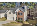 Charming two-story home featuring brick and siding, a manicured lawn, and an attached two-car garage at 414 Shadetree Ln, Lawrenceville, GA 30044