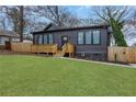 Charming home boasting dark siding, a welcoming porch, and a neatly manicured front yard at 875 Center Hill Nw Ave, Atlanta, GA 30318