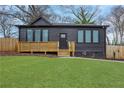 Beautiful home featuring dark siding, newer windows, and a quaint front porch at 875 Center Hill Nw Ave, Atlanta, GA 30318