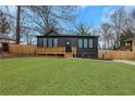 Inviting home with dark siding, large windows, and a charming wooden porch and green lawn at 875 Center Hill Nw Ave, Atlanta, GA 30318