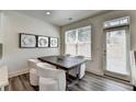 Cozy dining area with modern table and chairs next to a bright window at 2704 Ne Almand Ln, Conyers, GA 30013