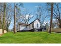 A lovely renovated home featuring black and white trim, outdoor deck, and a spacious green lawn at 3482 Atlanta St, Atlanta, GA 30337