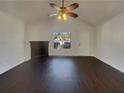 Bright living room with fireplace, ceiling fan, and hardwood floors at 7175 Bowie Dr, Lithonia, GA 30038