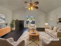 Bright living room with fireplace, ceiling fan, and plenty of space for entertaining at 7175 Bowie Dr, Lithonia, GA 30038