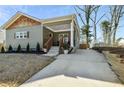 Classic craftsman home with welcoming front porch, wood railings, and an extended driveway for ample parking at 853 Gaston Sw St, Atlanta, GA 30310