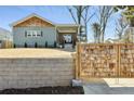 Charming home featuring stone retaining wall and a unique wood gate at 853 Gaston Sw St, Atlanta, GA 30310