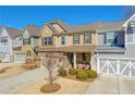 Charming townhome featuring a welcoming front porch and well-manicured landscaping at 2735 Kimblewick Ct, Cumming, GA 30040