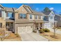 Charming townhome featuring a welcoming front porch and well-manicured landscaping at 2735 Kimblewick Ct, Cumming, GA 30040