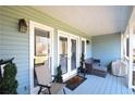 Charming covered porch with cozy seating area, stylish decor, and a welcoming atmosphere at 671 Benson Hurst Sw Dr, Mableton, GA 30126
