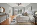 Serene main bedroom with tray ceilings, plush bedding, and large windows for ample natural light at 1016 Parkmont Way, Decatur, GA 30033