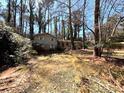 Two-story home with brick and siding exterior, nestled in a wooded lot with mature trees at 5169 Oxbow Rd, Stone Mountain, GA 30087