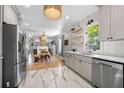 Bright, updated kitchen featuring stainless steel appliances, shaker cabinets and hexagon tile floors at 1015 Michigan Nw Ave, Atlanta, GA 30314