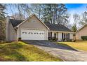 Charming single-story home with attached garage, well-maintained lawn, and cozy curb appeal at 1107 Sanfords Walk, Tucker, GA 30084