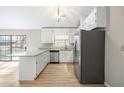 Well-lit kitchen featuring white cabinets, modern appliances, and a sliding glass door at 1107 Sanfords Walk, Tucker, GA 30084