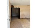 Entryway featuring unfinished flooring, damaged walls, and an open doorway to the next room at 13101 Waldrop Cv, Decatur, GA 30034