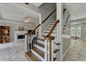 Open stairway connecting to living areas featuring wood stairs and white railings, creating a seamless flow at 5080 Firelight Ln, Alpharetta, GA 30022