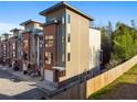 Modern townhome exterior with brick and siding, featuring clean lines and contemporary design at 975 Moda Dr, Atlanta, GA 30316