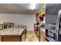 Kitchen area with stainless steel appliances, stone countertops, and ample cabinet space at 1155 Magnolia Gardens Walk, Mcdonough, GA 30253