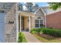 Inviting front entrance with brick facade, address display, and well-maintained landscaping at 3916 Abbott Way # 2, Powder Springs, GA 30127