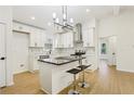 Stylish kitchen featuring white cabinets, black countertops, stainless steel appliances, and a kitchen island at 3469 Sexton Woods Dr, Atlanta, GA 30341