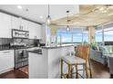 Open kitchen and living area with granite countertops, stainless steel appliances, and city views at 250 Pharr Ne Rd # 1618, Atlanta, GA 30305