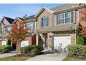 Charming brick townhome featuring a one-car garage, welcoming entryway, and beautifully maintained landscaping at 3117 Haynes Park Dr, Lithonia, GA 30038