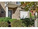 Attractive brick townhome with covered entryway, garage, and well-maintained bushes surrounding the house at 3117 Haynes Park Dr, Lithonia, GA 30038