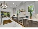 Modern kitchen with stainless steel appliances, light countertops, dark cabinets, and a view of the outdoor patio at 4201 Brookview Se Dr, Atlanta, GA 30339