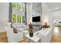Sun-filled living room with fireplace, hardwood floors, large windows, and modern decor at 4201 Brookview Se Dr, Atlanta, GA 30339