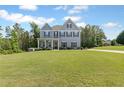 Charming two-story home featuring a well-manicured lawn and inviting curb appeal with a covered front porch at 8050 Tristan Way, Whitesburg, GA 30185