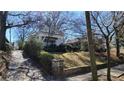 Quaint home nestled among trees with a stone pathway and attractive landscaping offering a serene setting at 1007 Blue Ridge Ne Ave, Atlanta, GA 30306