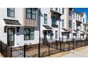 Charming townhouse exterior featuring painted brick, black trim, and inviting entryways with dark metal awnings at 516 Healy Dr # 69, Cumming, GA 30040