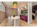 Charming dining room with textured walls, unique light fixture, and wet bar at 662 Timm Valley Ne Rd, Atlanta, GA 30305