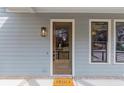 Welcoming entrance of home with beautiful wood door, neutral siding, and 'hello' doormat at 662 Timm Valley Ne Rd, Atlanta, GA 30305
