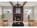 Cozy living room with a modern fireplace and exposed beams at 662 Timm Valley Ne Rd, Atlanta, GA 30305