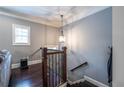 Elegant staircase with dark wood floors and decorative iron railing at 873 Cedar River Se Ct, Marietta, GA 30067