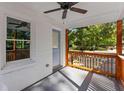 Covered front porch with wood railing and ceiling fan at 985 Columbia Dr, Decatur, GA 30030
