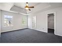 Spacious bedroom with ceiling fan, large windows, and a convenient walk-in closet at 1297 Quail Hunt Dr, Riverdale, GA 30296