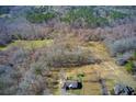 Aerial view showcases the home's setting amidst a wooded landscape at 1603 Drowning Creek Rd, Dacula, GA 30019