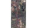 Aerial view of a property outlined in red, showing the land's boundaries and proximity to Drowning Creek at 1603 Drowning Creek Rd, Dacula, GA 30019