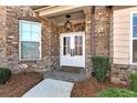 Charming brick home featuring a double front door, stone walkway and mature landscaping at 2196 Abbott Dr, Buford, GA 30519