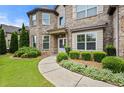 Charming home with well-maintained front yard, manicured bushes, and a welcoming walkway at 2196 Abbott Dr, Buford, GA 30519